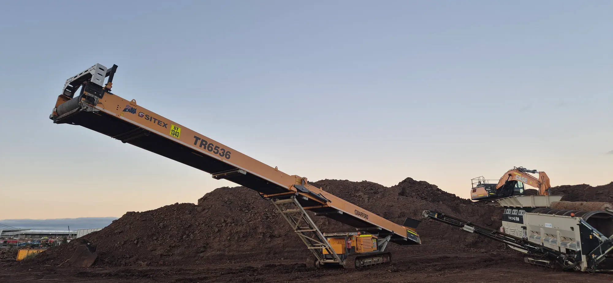 Tracked stockpiler building a stockpile at first light